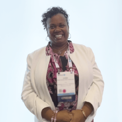 A photo of a woman giving a testimonial about Juno EHR